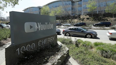 A YouTube sign is shown across the street from the company's offices in San Bruno, Calif., Tuesday, April 3, 2018. A woman opened fire at YouTube headquarters Tuesday, setting off a panic among employees and wounding several people before fatally shooting herself, police and witnesses said.