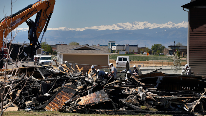 In this May 4, 2017, file photo, workers dismantle the charred remains of a house where an explosion killed two people in Firestone, Colo. A shareholder lawsuit alleges Anadarko Petroleum was focused on keeping old wells running, not fixing potential safety problems in the months before the fatal house explosion.