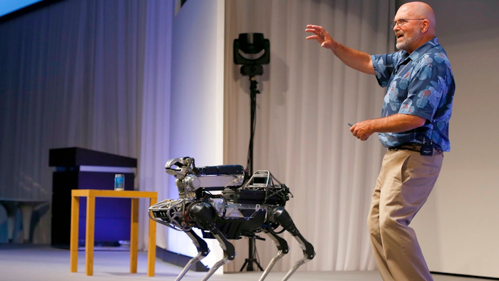 In this July 20, 2017 file photo, Boston Dynamics Chief Executive Marc Raibert speaks about his four-legged robot SpotMini during a SoftBank World presentation at a hotel in Tokyo. The robotics company known for its widely shared YouTube videos of nimble, legged robots opening doors or walking through rough terrain is finally preparing to sell some of them after years of research. Raibert said Friday, May 11, 2018, his company will begin selling the dog-like SpotMini robot next year, likely to businesses for use as a camera-equipped security guard. He made the announcement at a TechCrunch robotics conference at University of California, Berkeley.