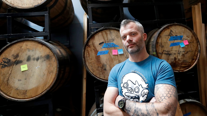 Jim Furman, CEO of Black Hammer Brewing, poses for photos in front of barrels in San Francisco, Thursday, May 24, 2018. U.S. officials have ordered the San Francisco brewery to stop producing beer containing cannabidiol, the hemp-derived extract known as CBD. The U.S. Alcohol and Tobacco Tax and Trade Bureau is allowing Black Hammer Brewing to sell the rest of the CBD beer it already brewed, including one called Toke Back Mountain.