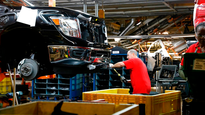 In this March 19, 2018, file photo, a technician tightens screws on the front bumper assembly at the Nissan Canton Assembly Plant, in Canton, Miss. On Tuesday, May 1, the Institute for Supply Management, a trade group of purchasing managers, issues its index of manufacturing activity for April.