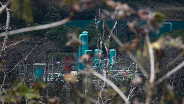 A a geothermal plant is seen from the Leilani Estates subdivision near Pahoa, Hawaii, Tuesday, May 22, 2018. Authorities were racing Tuesday to close off production wells at the plant threatened by a lava flow from Kilauea volcano on Hawaii's Big Island.