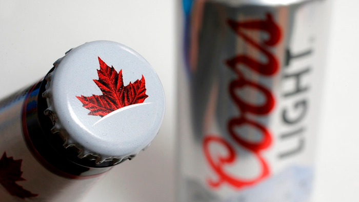 In this Nov. 28, 2017, file photo products from the Mondelez International family of brands, Molson beer, left, and Coors Light beer rest together, in Walpole, Mass. The Molson Coors Brewing Company reports earnings Wednesday, May 2, 2018.