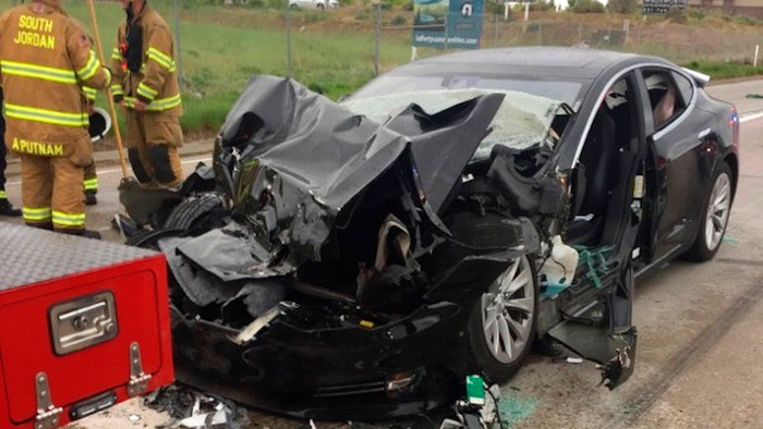 In this Friday, May 11, 2018, file photo released by the South Jordan Police Department shows a traffic collision involving a Tesla Model S sedan with a Fire Department mechanic truck stopped at a red light in South Jordan, Utah. The driver of a Tesla electric car that hit a Utah fire department vehicle over the weekend says the car's semi-autonomous Autopilot mode was engaged at the time of the crash. Police in the Salt Lake City suburb of South Jordan said Monday, May 14, 2018, the driver also said in an interview that she was looking at her phone before the accident. The 28-year-old woman broke her foot when her car hit a fire truck stopped at a red light while going 60 mph (97 kph).