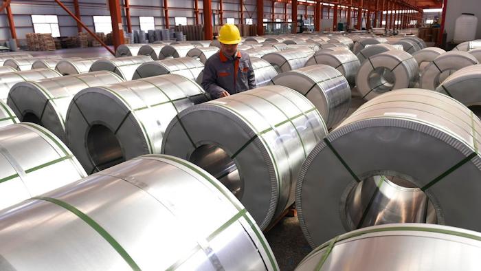 In this April 7, 2018, file photo, a worker checks on rolls of aluminum at a factory in Zouping county in east China's Shandong province. Small businesses are threatened by higher costs from U.S. steel and aluminum tariffs and by a broader trade fight with China, as steel costs are already higher since the Trump administration announced a 25 percent tariff on the metal in March.