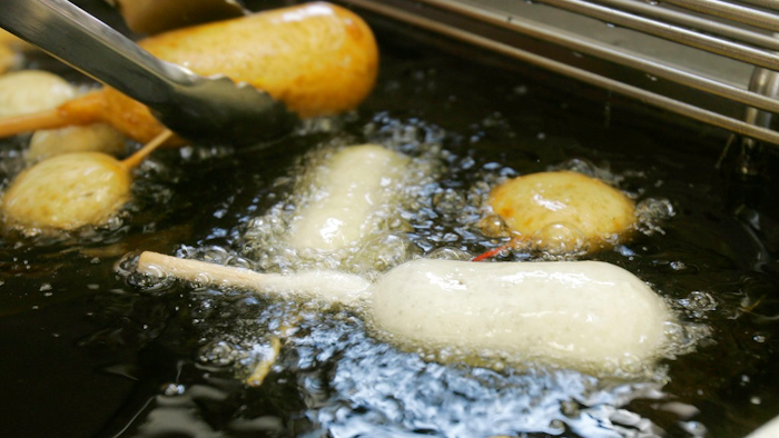 In this Aug. 8, 2007 file photo, a Milky-Way candy bar is deep-fried in oil free of trans fats at a food booth at the Indiana State Fair in Indianapolis. Indiana was the first state to require the switch at its state fair. On Monday, May 14, 2018, the head of the World Health Organization called on all nations to eliminate artificial trans fats from foods in the next five years.