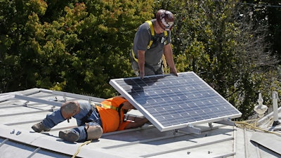 In this Oct. 16, 2015 file photo a solar panel is installed on the roof of the Old Governor's Mansion State Historic Park in Sacramento, Calif. After extensive renovations, Gov. Jerry Brown and his wife, Anne Gust Brown moved into the mansion in late 2015, becoming the first chief executive to live in the home since Ronald Reagan in 1967. The California Energy Commission will take up a proposal, Wednesday, May 9, 2018 , to require solar panels on new residential homes and low-rise apartment buildings up to three starting in 2020.