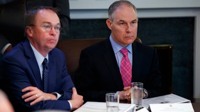 Director of the Office of Management and Budget Mick Mulvaney, left, and Environmental Protection Agency administrator Scott Pruitt listen to President Donald Trump speak during a cabinet meeting at the White House, Wednesday, May 9, 2018, in Washington.