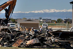 In this May 4, 2017, file photo, workers dismantle the charred remains of a house where an explosion killed two people in Firestone, Colo. A shareholder lawsuit alleges Anadarko Petroleum was focused on keeping old wells running, not fixing potential safety problems in the months before the fatal house explosion.