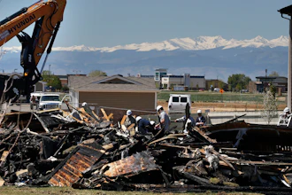 In this May 4, 2017, file photo, workers dismantle the charred remains of a house where an explosion killed two people in Firestone, Colo. A shareholder lawsuit alleges Anadarko Petroleum was focused on keeping old wells running, not fixing potential safety problems in the months before the fatal house explosion.