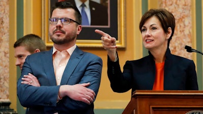 In this Jan. 8, 2018, photo Iowa Gov. Kim Reynolds does a walk through in the Iowa House chambers with deputy chief of staff Tim Albrecht, left, at the Statehouse in Des Moines, Iowa, before her Condition of the State address the next day. Albrecht has been hired by Apple months after helping promote a $208 million incentive package for the company's planned Iowa data center as a good deal for taxpayers. Albrecht departed as Reynolds' deputy chief staff, then began as manager of strategic initiatives for Apple in March.