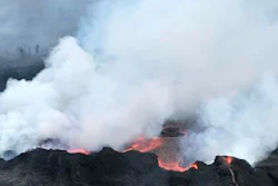 In this Saturday, May 26, 2018, image released by the U.S. Geological Survey HVO shows an aerial view of fissure 22 looking toward the south, as Kilauea Volcano continues its eruption cycle near Pahoa on the island of Kilauea, Hawaii. Lava from the Kilauea volcano has reached a geothermal power plant on the Big Island, approaching wells that have been capped to protect against the release of toxic gas should they mix with lava.