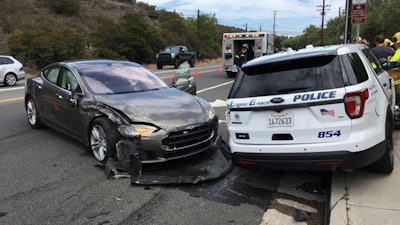 This photo provided by the Laguna Beach Police Department shows a Tesla sedan, left, in autopilot mode that crashed into a parked police cruiser Tuesday, May 29, 2018, in Laguna Beach, Calif. Police Sgt. Jim Cota says the officer was not in the cruiser at the time of the crash and that the Tesla driver suffered minor injuries.