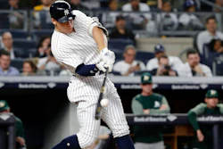 In this May 11, 2018, file photo, New York Yankees' Aaron Judge hits a three-run home run during the fifth inning of a baseball game against the Oakland Athletics in New York. Baseballs really are getting extra lift, and it's not from the exaggerated upper cuts batters are taking, according to a 10-person committee of researchers hired by the commissioner's office.