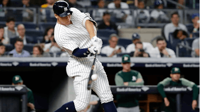 In this May 11, 2018, file photo, New York Yankees' Aaron Judge hits a three-run home run during the fifth inning of a baseball game against the Oakland Athletics in New York. Baseballs really are getting extra lift, and it's not from the exaggerated upper cuts batters are taking, according to a 10-person committee of researchers hired by the commissioner's office.