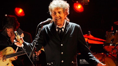 In this Jan. 12, 2012, file photo, Bob Dylan performs in Los Angeles. A distillery is partnering with Dylan to distill whiskey at a 140-year-old Tennessee church and bottle it under the name Heaven's Door. Media outlets reported Dylan partnered with Angel’s Envy Bourbon co-founder Marc Bushala in the venture.