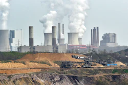 In this April 3, 2014 file photo giant machines dig for brown coal at the open-cast mining Garzweiler in front of a power plant near the city of Grevenbroich in western Germany. Allianz says it will stop insuring coal-fired power plants and coal mines as part of its contribution to combating climate change.