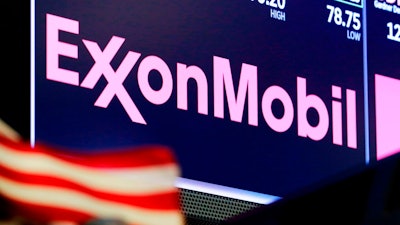 In this April 23, 2018, file photo, the logo for ExxonMobil appears above a trading post on the floor of the New York Stock Exchange. Energy stocks are leading U.S. indexes higher in early trading as the price of crude oil climb. Exxon Mobil added 1.2 percent early Monday, May 7, and Schlumberger rose 1.2 percent.