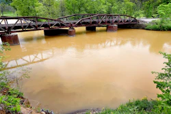 In this Tuesday, May 22, 2018 photo, sludge from the Hi-Crush mine in Whitehall, Wis. is seen in the Trempealeau River near Dodge, Wis. A contractor's bulldozer slid into a pond earlier this week, leading to an hours-long rescue at the Hi-Crush mine. Rescuers emptied the pond to free the man, requiring them to release 10 million gallons (37.8 million liters) of water and mud into the Trempealeau River tributary. The Wisconsin Department of Natural Resources is studying the sludge.