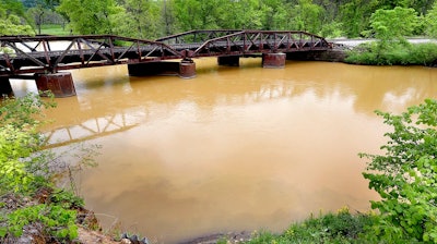 In this Tuesday, May 22, 2018 photo, sludge from the Hi-Crush mine in Whitehall, Wis. is seen in the Trempealeau River near Dodge, Wis. A contractor's bulldozer slid into a pond earlier this week, leading to an hours-long rescue at the Hi-Crush mine. Rescuers emptied the pond to free the man, requiring them to release 10 million gallons (37.8 million liters) of water and mud into the Trempealeau River tributary. The Wisconsin Department of Natural Resources is studying the sludge.