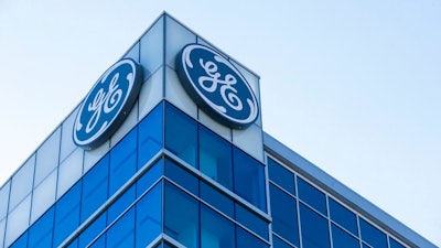 In this Jan. 16, 2018, file photo, the General Electric logo is displayed at the top of their Global Operations Center in the Banks development of downtown Cincinnati. General Electric is joining with Wabtec Corp. in a cash-and-stock deal as part of a move to help bolster its transportation unit.
