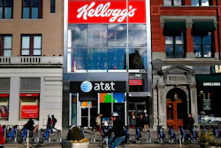 In this Dec. 14, 2017, file photo, people bike and walk by Kellogg's NYC Cafe at Union Square in New York. Kellogg Co. reports earnings Thursday, May 3, 2018.