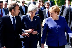 German Chancellor Angela Merkel, right, speaks with French President Emmanuel Macron, left, and British Prime Minister Theresa May after meeting at a hotel on the sidelines of an EU-Western Balkans summit in Sofia, Bulgaria, Thursday, May 17, 2018.