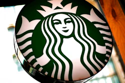 This March 24, 2018, file photo shows a sign in a Starbucks located in downtown Pittsburgh. Nestle has entered an agreement to bring Starbucks products to millions of homes worldwide, announced Monday, May 7, 2018.