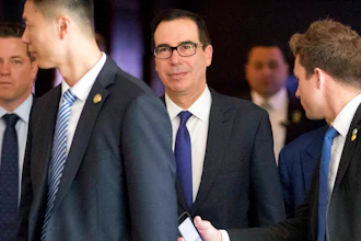 U.S. Treasury Secretary Steven Mnuchin, center, leaves his hotel in Beijing, Friday, May 4, 2018. A high-powered U.S. delegation met for a second day of talks with Chinese officials on defusing tensions that are propelling the world's largest two economies toward a trade war.
