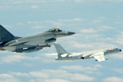 This file photo shows a Taiwanese Air Force fighter aircraft, left, near a Chinese People's Liberation Army Air Force H6-K bomber that reportedly flew over the Luzon Strait south of Taiwan during an exercise.