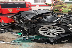 This photo shows a traffic collision involving a Tesla Model S sedan with a Fire Department mechanic truck stopped at a red light in South Jordan, Utah.