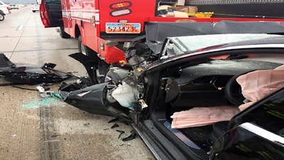 This Friday, May 11, 2018, photo released by the South Jordan Police Department shows a traffic collision involving a Tesla Model S sedan with a Fire Department mechanic truck stopped at a red light in South Jordan, Utah.