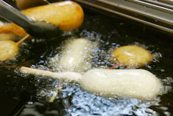 In this Aug. 8, 2007 file photo, a Milky-Way candy bar is deep-fried in oil free of trans fats at a food booth at the Indiana State Fair in Indianapolis. Indiana was the first state to require the switch at its state fair. On Monday, May 14, 2018, the head of the World Health Organization called on all nations to eliminate artificial trans fats from foods in the next five years.