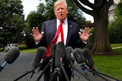 President Donald Trump's hair is ruffled by a breeze as he speaks to the media on the South Lawn of the White House in Washington, Wednesday, May 23, 2018, en route to a day trip to New York. Trump will hold a roundtable discussion on Long Island on illegal immigration and gang violence that the White House is calling a 'national call to action for legislative policy changes.'