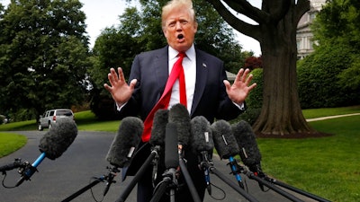 President Donald Trump's hair is ruffled by a breeze as he speaks to the media on the South Lawn of the White House in Washington, Wednesday, May 23, 2018, en route to a day trip to New York. Trump will hold a roundtable discussion on Long Island on illegal immigration and gang violence that the White House is calling a 'national call to action for legislative policy changes.'