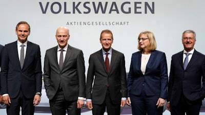 Herbert Diess, center , CEO of the Volkswagen stock company, and the members of the Board of Management of Volkswagen, Hiltrud Dorothea Werner, 2nd right, and Frank Witter, 2nd left, Oliver Blume, left, CEO of Porsche AG, and Rupert Stadler, right, CEO of Audi AG, pose for the media prior to the shareholder's meeting in Berlin, Germany, Thursday, May 3, 2018.