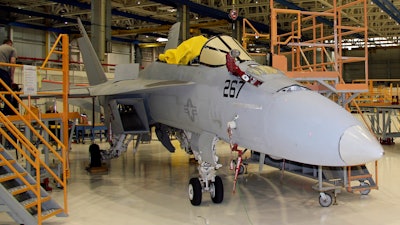 In this Wednesday, April 25, 2018, photo, the first F/A-18 Super Hornet, of many to come, undergoes updates and maintenance at Boeing's facility in St. Louis. This fighter aircraft was delivered by Boeing to the U.S. Navy in November 2004 and is at the end of its lifespan. After being refurbished, it can be piloted for an additional 3,000 flight hours, or 10-15 years.