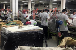 In this photo taken Thursday, May 24, 2018, and released by the Royal Thai Police, factory workers process electronic waste in Lat Krabang, outside Bangkok, Thailand. Police have raided several factories near Bangkok that allegedly were processing illegally imported electronic waste in a sign that China’s crackdown on waste recycling is pushing such operations offshore.