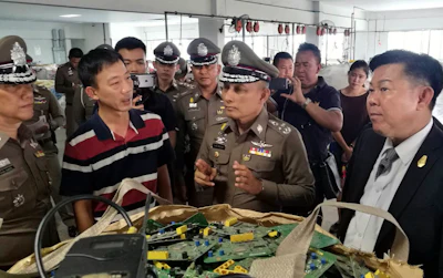 In this photo taken Thursday, May 24, 2018, and released by the Royal Thai Police, a factory processing electronic waste is visited by police in Lat Krabang, outside Bangkok, Thailand. Police have raided several factories near Bangkok that allegedly were processing illegally imported electronic waste in a sign that China’s crackdown on waste recycling is pushing such operations offshore.