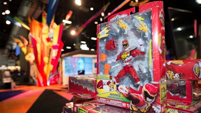 In this July 8, 2015, file photo, a Power Rangers figure sits on display at a booth before Preview Night at Comic-Con International held at the San Diego Convention Center in San Diego. Hasbro is buying the Power Rangers and some other toy brands from Saban Properties in a cash-and-stock deal valued at about $522 million.