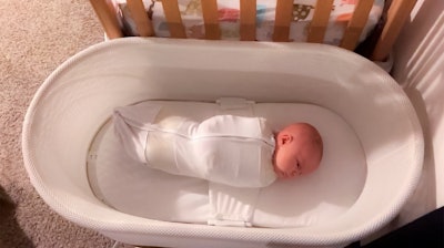 This Jan. 3, 2017 photo released by Paul Zalewski shows his infant daughter Ruby in a smart-tech sleeper called the Snoo, which gently rocks and jiggles babies to sleep from birth to 6 months old.