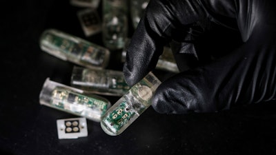 This undated photo provided by the Massachusetts Institute of Technology School of Engineering in May 2018 shows a capsule packed with electronics and genetically engineered living cells in Cambridge, Mass. Researchers at MIT, who tested the swallowable device in pigs, say it correctly detected signs of bleeding. The results, published online Thursday, May 24, 2018 by the journal Science, suggest a smaller version of the capsule could eventually be used in humans to find signs of ulcers, inflammatory bowel disease or even colorectal cancer.