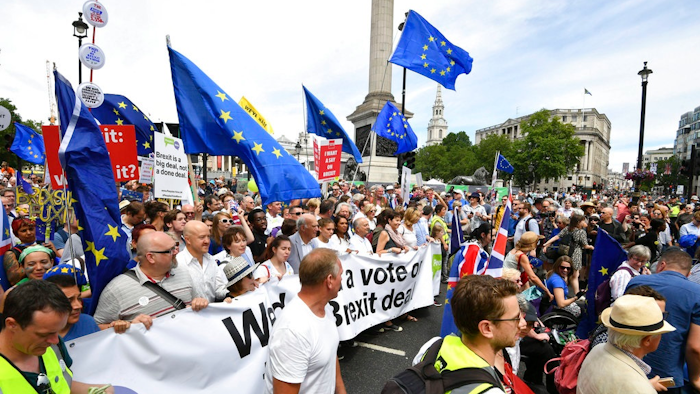 From centr carrying banner, British lawmaker Vince Cable, Pro-EU campaigners Gina Miller, Tony Robinson and lawmaker Caroline Lucas join crowds taking part in the People's Vote march for a second EU referendum, at Trafalgar Square in central London, Saturday June 23, 2018. Leading Brexit supporters are talking tough, and opponents are taking to the streets, on the second anniversary of Britain's vote to leave the European Union. Saturday marks two years since a June 23, 2016 referendum resulted in a decision to quit the 28-nation EU.