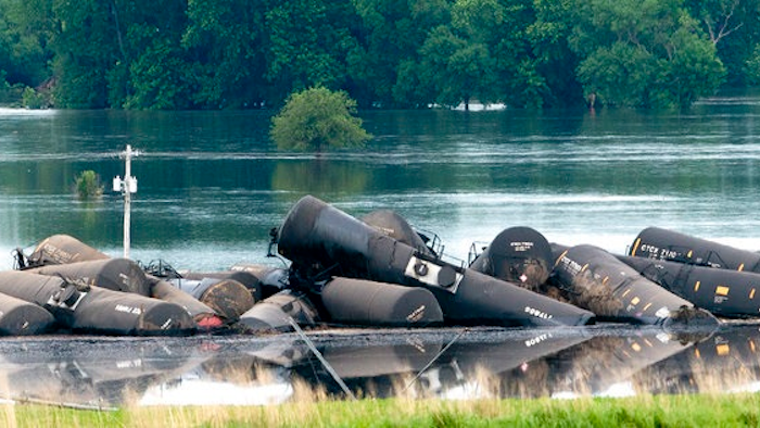 Tank cars carrying crude oil are shown derailed about a mile south of Doon, Iowa, Friday, June 22, 2018. About 31 cars derailed after the tracks reportedly collapsed due to saturation from flood waters from adjacent Little Rock River.