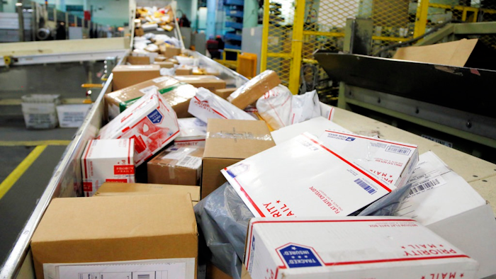 In this Dec. 14, 2017, file photo, packages travel on a conveyor belt for sorting at the main post office in Omaha, Neb. States will be able to force shoppers to pay sales tax when they make online purchases under a Supreme Court decision Thursday, June 21, 2018, that will leave shoppers with lighter wallets but is a big win for states.