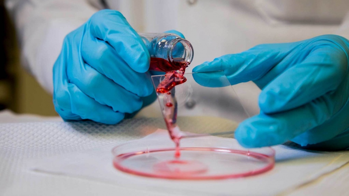 Mathew Boban, a graduate student research assistant at the University of Michigan, pours hexadecane oil onto a glass slide covered with an omniphobic coating. The petroleum-based, highly viscous oil slides easily off the glass. The Office of Naval Research is sponsoring efforts to see how omniphobic coatings might reduce friction drag—resistance created by the movement of a hull through water—on ships, submarines and unmanned underwater vessels.