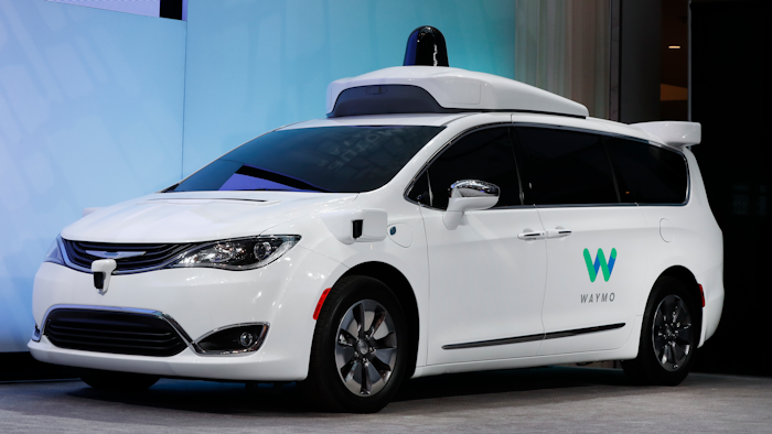 In this Jan. 8, 2017, file photo a Chrysler Pacifica hybrid outfitted with Waymo's suite of sensors and radar is displayed at the North American International Auto Show in Detroit. A self-driving car service that Google spinoff Waymo plans to launch later this year in Arizona will include up to 62,000 Chrysler Pacifica Hybrid minivans under a deal announced Thursday, May 31, 2018.