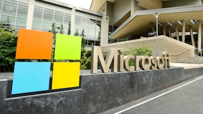 This July 3, 2014 file photo shows Microsoft Corp. signage outside the Microsoft Visitor Center in Redmond, Wash. Microsoft says it's paying $7.5 billion in stock for the popular coder hangout GitHub.