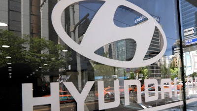 In this Wednesday, April 26, 2017, file photo, the logo of Hyundai Motor Co. is displayed at the automaker's showroom in Seoul, South Korea. Hyundai Motor Group on Wednesday says it has signed an agreement with Audi AG to jointly develop electronics vehicles powered by fuel cell.