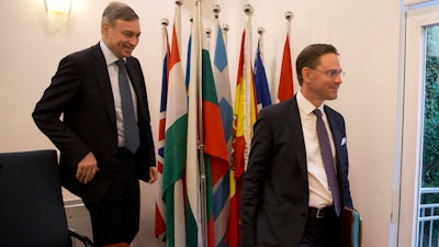 European Union's Ambassador to China Hans Dietmar Schweisgut, left and European Commission Vice President Jyrki Katainen leaves after a press conference in Beijing, China, Monday, June 25, 2018. The vice president of the European Union's governing body says Europe and China will form a group aimed at updating global trade rules to address technology policy, subsidies and other emerging complaints in a bid to preserve support for international commerce.